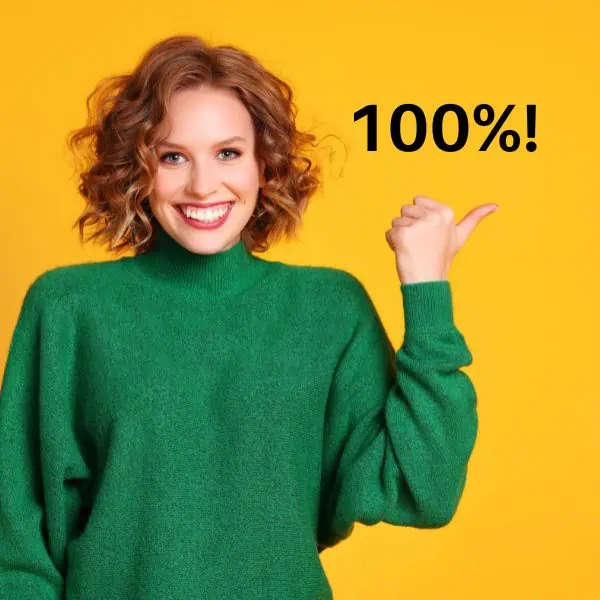 Smiling redheaded girl in a green pullover with a yellow background and 100% - 39 Simple Tips for Your Best C1 Advanced Writing